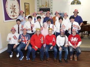 Union jacks and crowns adorn members of the CAMP Rehoboth Chorus bass section.