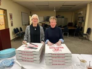 UNICO outreach committee members Karen Coombe, left, and Joan Boraski, chair, prepare to hand out Nicola Pizza slices at Italian movie night. SUBMITTED PHOTOS