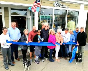 Participants at the Odysea ribbon cutting are (l-r) Carolyn Diefenderfer; Jack Riddle, Community Bank Delaware president; Karin Kampmann; Michael Callaghan with Buddy; Wanda Guyton; Dick Byrne, Rehoboth Beach Main Street board president; Suzie Martin, RBMS board vice president; owners Mary Anne Callaghan and Patrick Turner; former owner Carol Dryer with Reef; Steve Scheffer; and James Mease. SUBMITTED PHOTO