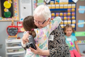 Pre-K teacher Diane Camper, right, greets a former student at back-to-school night.