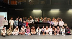 Cape performing arts students gather around the newly donated piano with True Blue Jazz representative Peggy Raley.