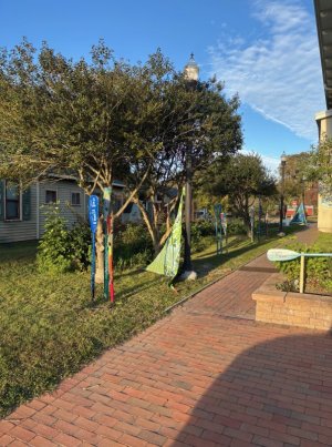 Sails created by local adult artists greet visitors at the exhibition’s two entrances along the Governors’ Walk section next to the public library.