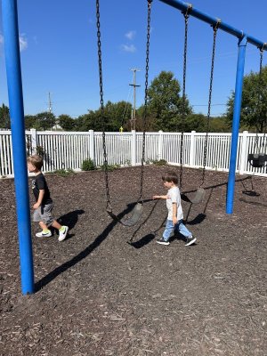 Scampering away from the swings are Jackson Hart, left, and Connor Fickett.