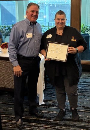 Accepting a Cape Henlopen Food Basket certificate of appreciation from board member Mark Sievers, left, is Michelle Atkinson, customer service manager for Giant Food Rehoboth Beach.