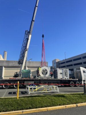 The 1.5 Tesla MRI arrives on site, secured on a truck bed before installation begins.