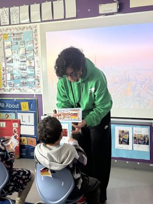 Little Vikings student Koby Grace, left, reads off his boarding pass to teacher Traci Dabbs.