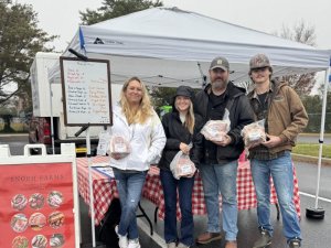 Enoch Farms representatives displaying their sustainably raised, naturally grown pork products are (l-r) Hannah Combs, Maddie Combs, Randy Combs and Conner Combs.