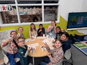 Cape Academic Power Enrichment Club members enjoying donuts for the semester celebration are (clockwise from front left) Grady Porter, Hanna Burk, Alannah Dunne, Skylar Grubbe, Dominic Montoya, Sophia Mockewich, Janae Turnage, Darlyn Medina, and Delia Legg.