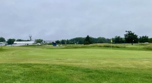 The first green on the Bay Course at Seaview Resort is not only small, but also becomes even smaller because of its design. The back half of the green slopes down and away, giving balls a greater chance to roll off it and into the rough beyond.
