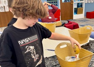 Graham Waters competes with his potato in the diving competition.