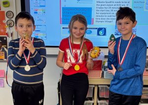 Downhill competition medal winners shown are (l-r) Joaquin Cortez-Garcia, second place; Bella Pease, first place; and Griffin Eanes, third place.