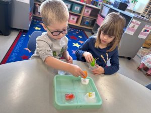 Donovan Gillespy and Rory Suess work together on melting their ice cubes