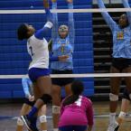 Cape sophomore hitter Katie Knarr, center, and Mikiyah Ennals get up to block Dover’s Victoria Anyanwu.
