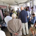 The crowd gathers around to hear Sen. Tom Carper.