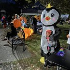 Kamryn Johnson, 5, takes a picture with the Milton Mailboxes penguin.