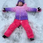 Teagan Parker of Lincoln makes a snow angel.