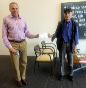 Mark Engberg of Charles Schwab Rehoboth Beach presents a donation check for the Milton Community Food Pantry to Tom DiOrio, board member for special projects. SUBMITTED PHOTO