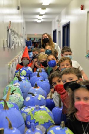 Worcester Prep students shown displaying their pumpkin globes are in back (l-r) Evan Kaufaman, Seva Nistazos, Soloman Prosser, Eli Parker, Allie Kuon, and third-grade teacher Annie Seipp. In front are Bryan Anderson, Gavin Dennis, Tejal Pillai, Mason Gerner, Allen Martikyan, Colt Duffie and Olivia Mason. SUBMITTED PHOTO