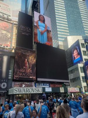 Celebrating as her image lights up on New York City’s Times Square Jumbotron is Gabby Parillon of Lewes, in town for the New York City Buddy Walk. SUBMITTED PHOTO