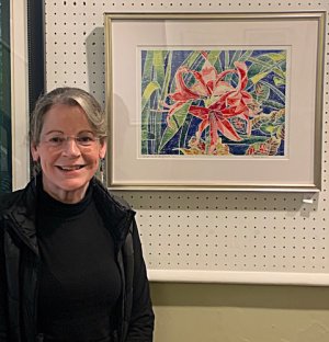 Theresa Kehrer is shown with her color woodcut print, “Christmas at Longwood.” SUBMITTED PHOTO
