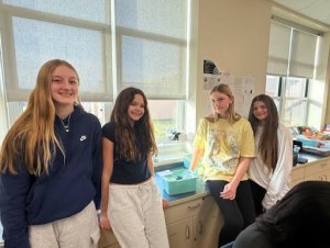 Beacon Middle School eighth-graders standing next to their solar water still are (l-r) Clover Webb, Holland Mamele, Jorja Truitt and Simone Bodis. SUBMITTED PHOTOS