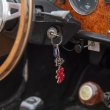 Key fobs representing the car dangle off the steering wheel.