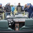 A green Morgan Plus 8 gets lots of attention at the car show.