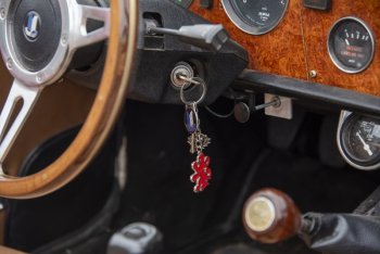 Key fobs representing the car dangle off the steering wheel.