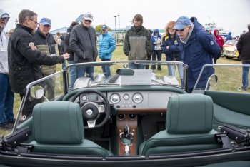 A green Morgan Plus 8 gets lots of attention at the car show.