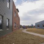 Landscaping will soon liven the courtyard walk to the playground.